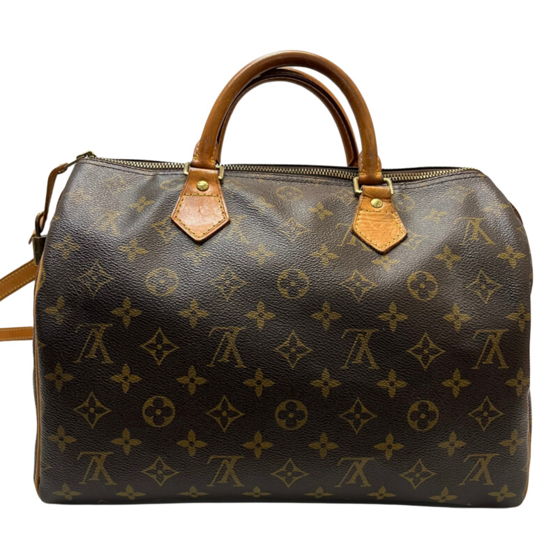 Louis Vuitton Speedy 30 Handbag<br />
Quality Made Leather with Monogram Print<br />
Top Handle Bag with Strap<br />
From the 1991 Collection<br />
Brown Coated Canvas<br />
Brass Hardware<br />
Rolled Handles<br />
Leather Trim Embellishment<br />
Canvas Lining & Single Interior Pocket<br />
Zip Closure at Top