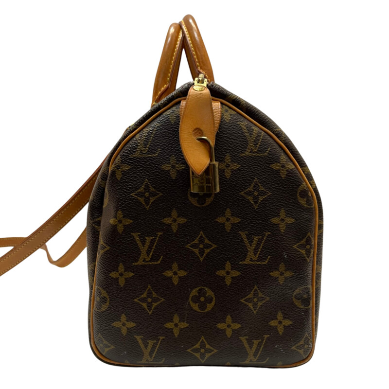 Louis Vuitton Speedy 30 Handbag<br />
Quality Made Leather with Monogram Print<br />
Top Handle Bag with Strap<br />
From the 1991 Collection<br />
Brown Coated Canvas<br />
Brass Hardware<br />
Rolled Handles<br />
Leather Trim Embellishment<br />
Canvas Lining & Single Interior Pocket<br />
Zip Closure at Top