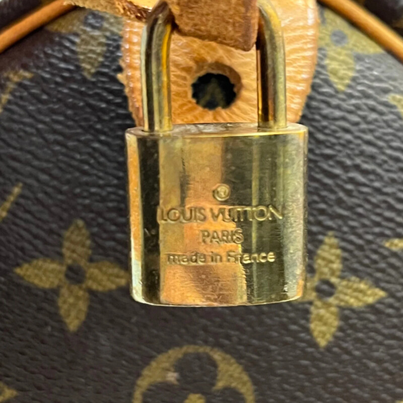 Louis Vuitton Speedy 30 Handbag<br />
Quality Made Leather with Monogram Print<br />
Top Handle Bag with Strap<br />
From the 1991 Collection<br />
Brown Coated Canvas<br />
Brass Hardware<br />
Rolled Handles<br />
Leather Trim Embellishment<br />
Canvas Lining & Single Interior Pocket<br />
Zip Closure at Top