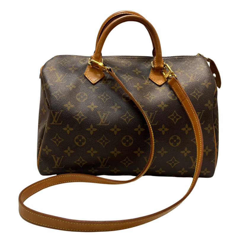 Louis Vuitton Speedy 30 Handbag<br />
Quality Made Leather with Monogram Print<br />
Top Handle Bag with Strap<br />
From the 1991 Collection<br />
Brown Coated Canvas<br />
Brass Hardware<br />
Rolled Handles<br />
Leather Trim Embellishment<br />
Canvas Lining & Single Interior Pocket<br />
Zip Closure at Top