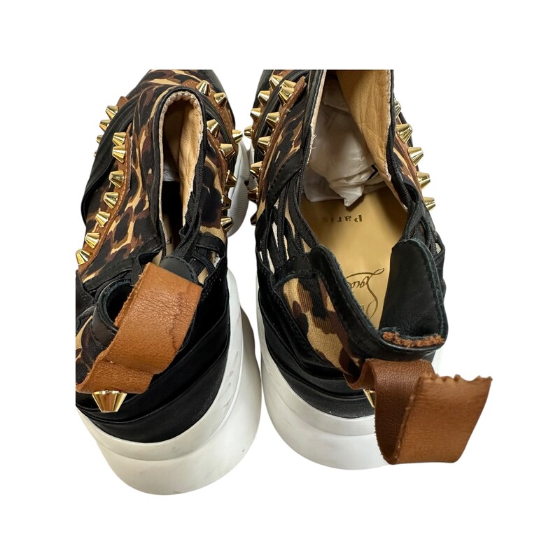 Christian Louboutin 123 Run Sneakers<br />
<br />
Size 39<br />
<br />
Leopard print satin<br />
<br />
Black & brown leather<br />
<br />
Rear pull strap of right shoe is torn<br />
<br />
Rear pull strap of left shoe is stained<br />
<br />
Does not come with original dust bag or box