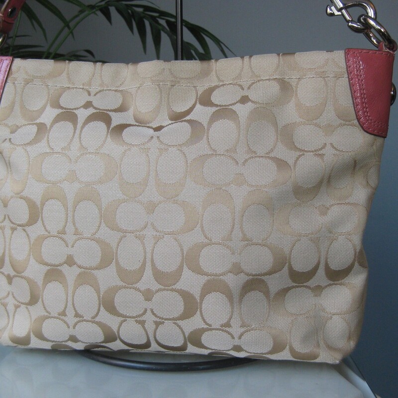 Coach Logo Lthr Flowers, Tan/pink, Size: None<br />
Pretty and girly Coach Carly bag.<br />
<br />
Light brown coach logo jacquared with studs and leather and suede flowers attached to the outside.<br />
Pink patent leather trim and Coach logo hangtag<br />
Silver hardware, top zipper,<br />
baby pink satin interior with two slip pockets and one zippered pocket.<br />
The handle is removeable.<br />
11 x 8.5 x 3.5 at the bottom, a bit less deep at the top<br />
Handle drop: 7.5<br />
<br />
excellent condition.  The pink flowers have some darkness at the highest relief points, please see all the photos.<br />
thanks for looking!<br />
#80375