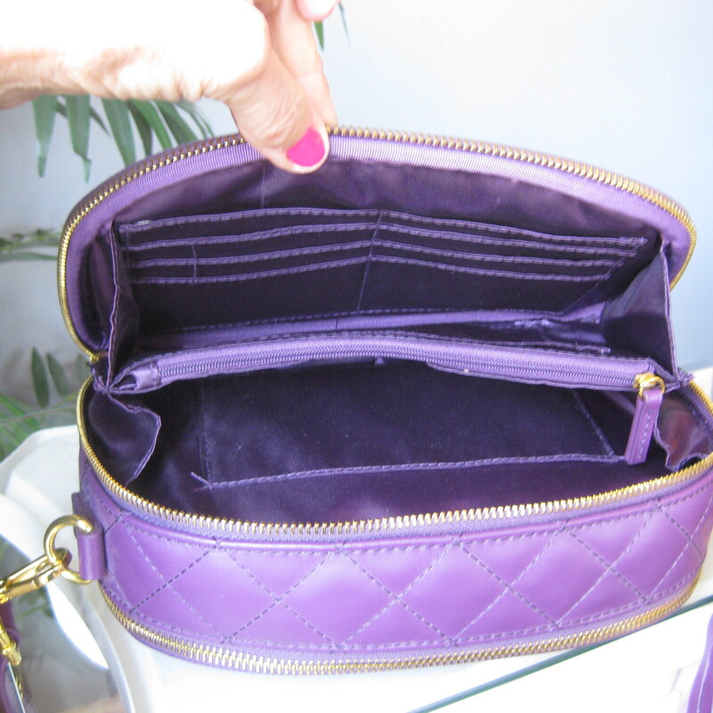 Double sided crossbody bag from Joy & Iman Joy Mangano<br />
Irresistable shade of Purple<br />
Quilted Crossbody Bag<br />
New without tags<br />
<br />
10-inches wide<br />
6-inches high<br />
3-inches deep<br />
Oval Shape<br />
Outer magnetic slip pocket<br />
2 zip compartments<br />
Card slots<br />
inner dividers<br />
Tassel bag charm (non-removable)<br />
Adjustable strap, 27  max, 14 minimum<br />
<br />
Like new condition!<br />
Thanks for looking!<br />
#81205