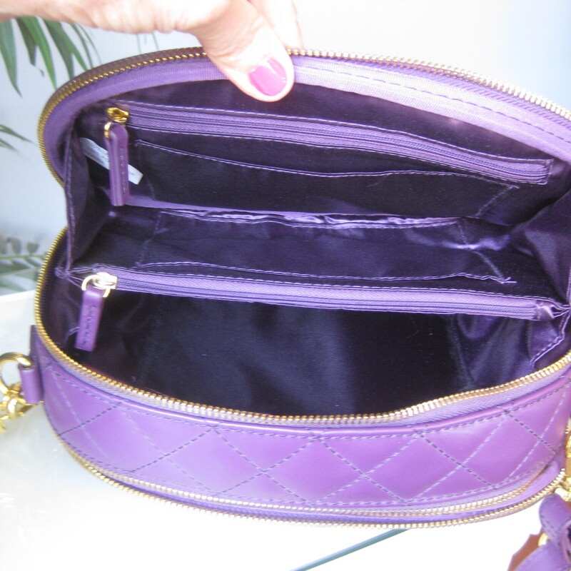 Double sided crossbody bag from Joy & Iman Joy Mangano<br />
Irresistable shade of Purple<br />
Quilted Crossbody Bag<br />
New without tags<br />
<br />
10-inches wide<br />
6-inches high<br />
3-inches deep<br />
Oval Shape<br />
Outer magnetic slip pocket<br />
2 zip compartments<br />
Card slots<br />
inner dividers<br />
Tassel bag charm (non-removable)<br />
Adjustable strap, 27  max, 14 minimum<br />
<br />
Like new condition!<br />
Thanks for looking!<br />
#81205