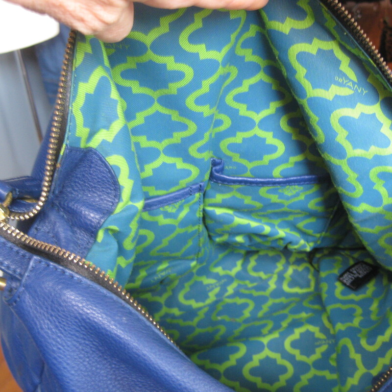 Very Roomy leather shoulder bag<br />
by Oryany<br />
This is their Adele bag<br />
Royal blue leather exterior with a large white slip pocket outside<br />
Black leather handle<br />
designer inspired cotton lining with two slip and 2 zippered pockets<br />
Top zip closure, brass bottom studs<br />
NWOT, original dust bag and crossbody strap  included<br />
13 x 13 x 4<br />
shoulder strap drop: 6<br />
crossbody strap is about 22 max and is adjustable.<br />
<br />
Thanks for looking!<br />
#80384