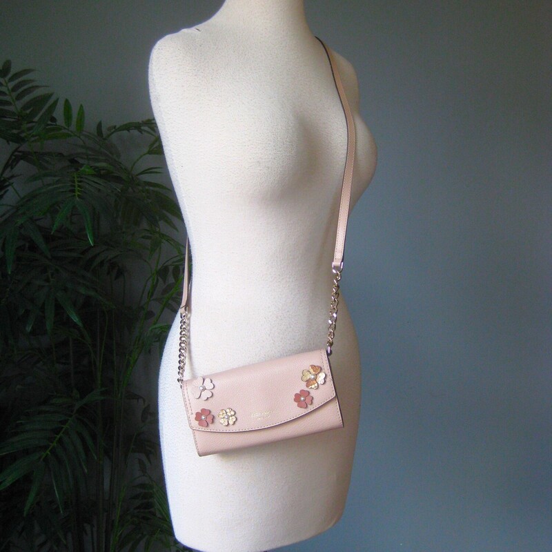 Adorable and functional Kate Spade crossbody.<br />
cool tone blush pink leather with little flower appliques<br />
It's really a wallet on a strap, outfitted with cards slots, space for bills & receipts and a zip pocket inside.<br />
magnetic snap as the main closure<br />
The chain and leather strap can be removed<br />
7.5 x 4.5 x 1.5<br />
excellent like new condition.<br />
<br />
thanks for looking!<br />
#80543