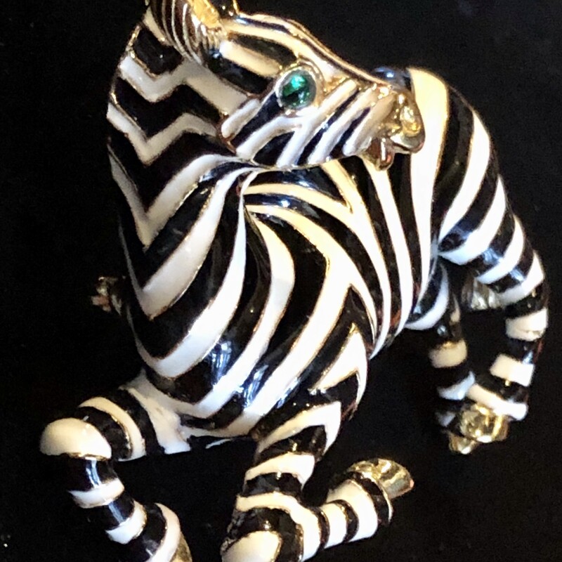 This is a Vintage Ciner Zebra Brooch, gold plate & enameled with green eyes. It's 2 3/4in x 2in and is in perfect condition.<br />
Ciner was founded in 1892, first producing fine jewelry then transitioning to costume jewelry in 1931. All the work was still done by hand. Ciner was known for using 18k gold plating, high-quality glass beads and stones, & rich enameling giving the jewelry a substantial feel and longevity in wear. This emphasis on quality is why costume jewelry collectors prize vintage Ciner pieces today.