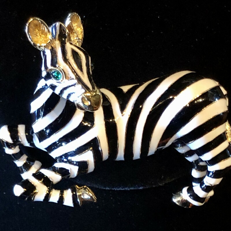 This is a Vintage Ciner Zebra Brooch, gold plate & enameled with green eyes. It's 2 3/4in x 2in and is in perfect condition.<br />
Ciner was founded in 1892, first producing fine jewelry then transitioning to costume jewelry in 1931. All the work was still done by hand. Ciner was known for using 18k gold plating, high-quality glass beads and stones, & rich enameling giving the jewelry a substantial feel and longevity in wear. This emphasis on quality is why costume jewelry collectors prize vintage Ciner pieces today.