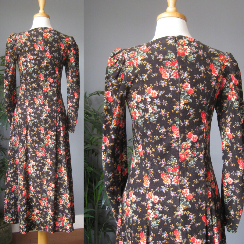 Vtg Laura Ashley Velvet, Blk/red, Size: 4<br />
This Laura Ashley dress is made of baby corduroy in a floral print.  The print has a black background which keeps it from being too 'sweet' and red and pink roses.  The long sleeves are puffy at the top.  The skirt is also very full and gathered into the defined waist line.<br />
The dress is 100% Cotton, nice and soft and unlined.<br />
Center back zipper<br />
Made in the UK<br />
<br />
It is marked size 4,  but it BARELY fits on my modern size for mannequin so please take the measurements I've provided below seriously, let me know if you have any questions about the f it I will get right back to you!<br />
<br />
 here are the flat measurements, please double where appropriate:<br />
Shoulder seam to shoulder seam: 14.5<br />
Armpit to Armpit: approx 17<br />
Waist: 14 1/2<br />
Hips: free up to 21.75<br />
length: 49<br />
Underarm sleeve seam: 16.5,<br />
sleeve from shoulder to cuff: 24<br />
Excellent condition! no flaws<br />
<br />
Thanks for looking.<br />
#80800