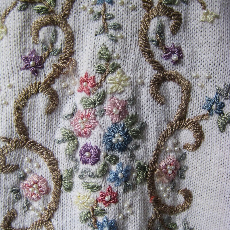 Vtg Jenny Embrd, Baby Pin, Size: Medium<br />
This sweater by Jenny is from the 1980s or maybe early 90s<br />
Very pretty embroidered all over with flowers, scrolling vines and pearls.<br />
Tunic length with decorated long sleeves<br />
Cotton Ramie blend<br />
Four pearl buttons at the neck that do open.<br />
the background appears white but it's actually the palest of pale pinks.<br />
Here are the flat measurements, please double where appropriate:<br />
Shoulder to shoulder: 22 these are 'dropped shoulders' the shoulder seam will hand down your arm a couple of inches.<br />
Armpit to armpit: 22.5<br />
Width at hem: 22<br />
Underarm sleeve seam length: 17<br />
Length from neck to hem: 26<br />
Excellent condition, minor imperfection or two on the embroidery floss near the waist area, pls see all of my photos.<br />
Thanks for looking!<br />
#79452