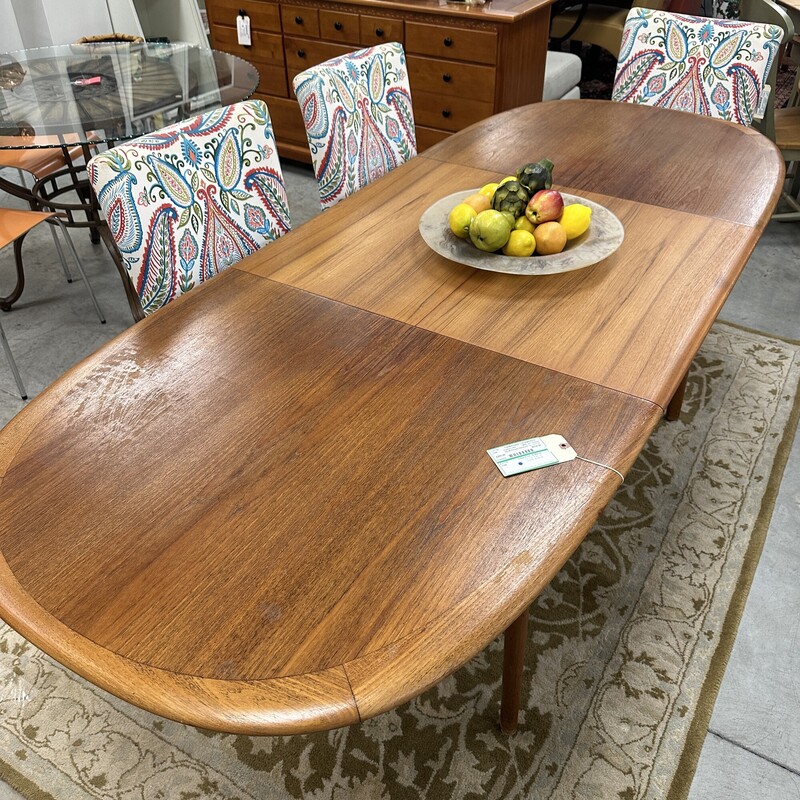 Beautiful Mid Century Modern Elsteds Dining Table, made in Denmark Table circa 1960s.
Size: 63L x 36W, PLUS one self-storing 30in leaf. Table only; no chairs are included.