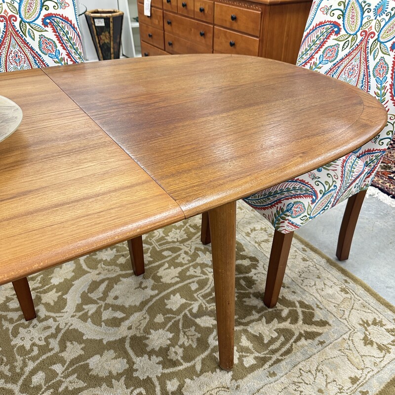 Beautiful Mid Century Modern Elsteds Dining Table, made in Denmark Table circa 1960s.
Size: 63L x 36W, PLUS one self-storing 30in leaf. Table only; no chairs are included.