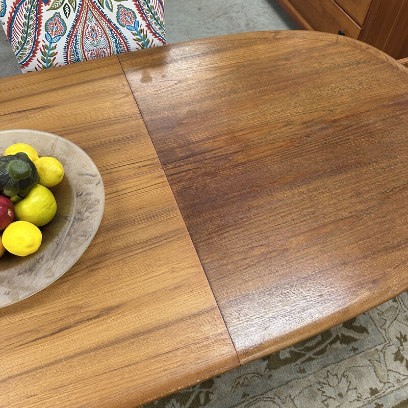 Beautiful Mid Century Modern Elsteds Dining Table, made in Denmark Table circa 1960s.
Size: 63L x 36W, PLUS one self-storing 30in leaf. Table only; no chairs are included.