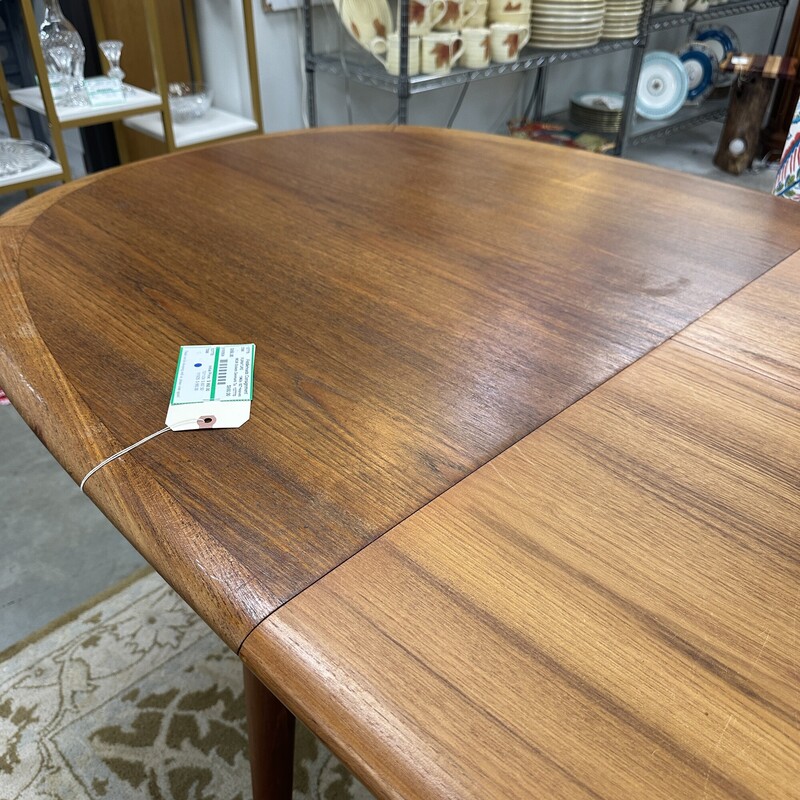 Beautiful Mid Century Modern Elsteds Dining Table, made in Denmark Table circa 1960s.
Size: 63L x 36W, PLUS one self-storing 30in leaf. Table only; no chairs are included.