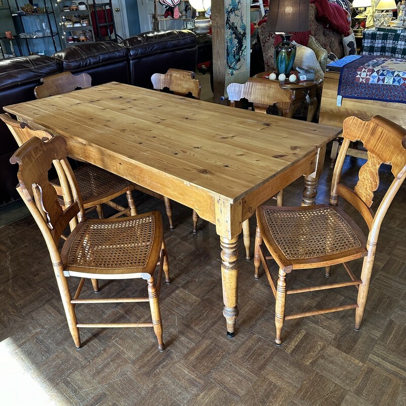 Harvest Table/6 Chairs,
Size: 68x31x31
Beautiful English Pine Harvest table.  Hard pine in beautiful condition.  6 Tiger Maple chairs with cane seats make this a beautiful set!