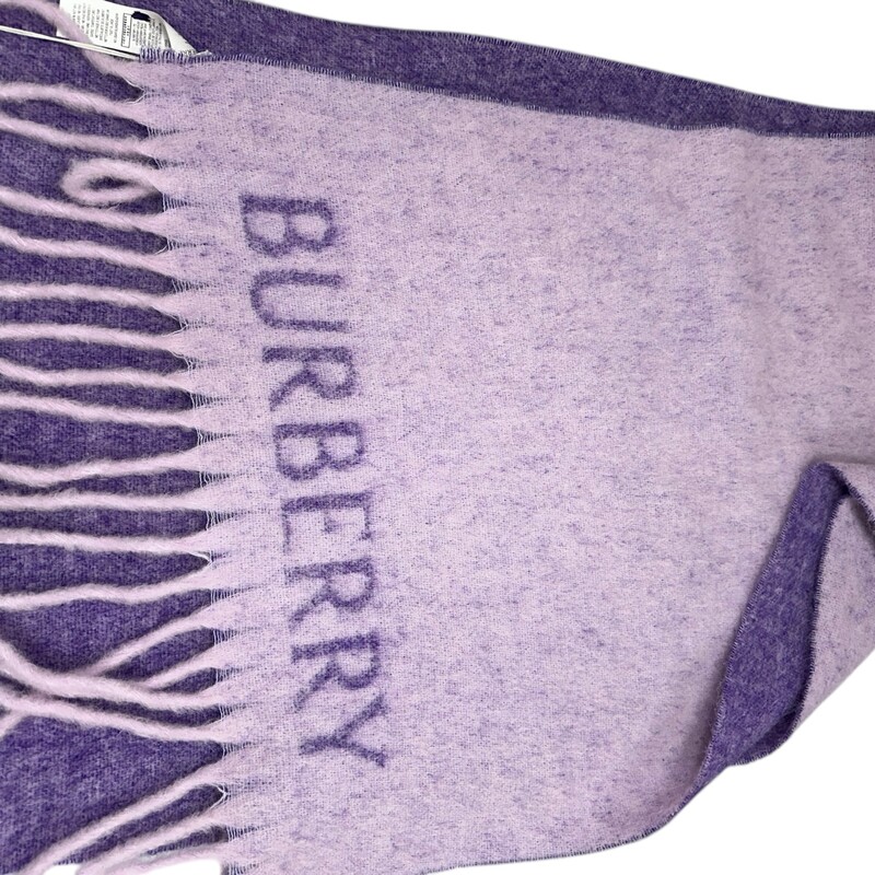 Burberry Oversized Logo Wrap<br />
Lilac<br />
New with tags<br />
21 x 84; 6 fringe<br />
Does not come with original box or dust bag.<br />
Compostion: 21% Alpaca Wool