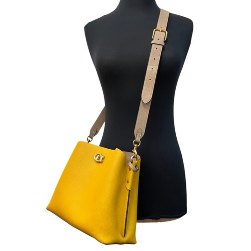 Coach Leather Willow Handbag<br />
Tan Colored Leather Strap<br />
Gold Hardware with C for Coach Closure<br />
Inside multifunction pocket, center zip compartment<br />
4 protective feet at base<br />
9 1/4 L x 8 3/4 H x 4 1/4 W<br />
Color: Mustard