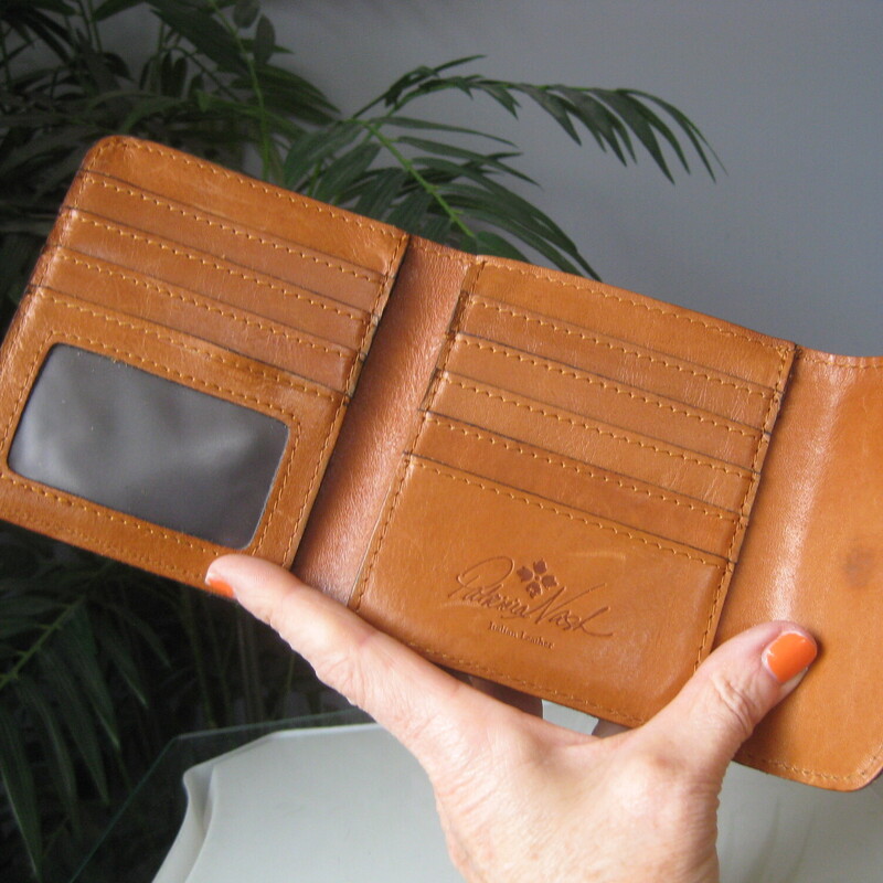 Patricia Nash trifold wallet.<br />
Romantic softly colored flowers on the outside<br />
rich tan on the inside.<br />
kisslock change purse with soft suede interior and copper colored metal frame<br />
8 card slots<br />
ID slot<br />
2 slip pockets for bills and receipts<br />
There are also slip pockets behind the card slots<br />
4 5/8 x 4 1/2 x about 1 1/2<br />
excellent condition!<br />
Thanks for looking!<br />
#81445