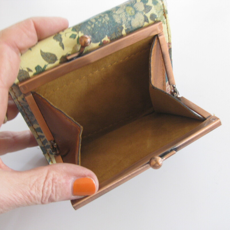 Patricia Nash trifold wallet.<br />
Romantic softly colored flowers on the outside<br />
rich tan on the inside.<br />
kisslock change purse with soft suede interior and copper colored metal frame<br />
8 card slots<br />
ID slot<br />
2 slip pockets for bills and receipts<br />
There are also slip pockets behind the card slots<br />
4 5/8 x 4 1/2 x about 1 1/2<br />
excellent condition!<br />
Thanks for looking!<br />
#81445