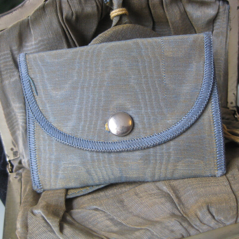 Pretty blue velvet pouch with a silver frame and a velvet handle.<br />
The bag is shaped like a pouch and has a tassel at the bottom.<br />
The frame is silver, possibly sterling ? molded in Art Nouveau style with a steel hinged clasp.<br />
Inside the lining is a watered silk like fabric,<br />
It's outfitted with a small round mirror and a tiny slip case with a snap closure.<br />
It also has a tiny silver key, added by its owner, attached with an old piece of string.<br />
what was it for?!<br />
It measures:<br />
6.25 wide at its widest part<br />
7.5 tall, flat when empty<br />
handle drop: 5.5<br />
<br />
excellent condition, tarnish and a bit of corrosion on the silver frame, clasp works smoothly, clean and damage free inside and out.<br />
thanks for looking!<br />
#67996