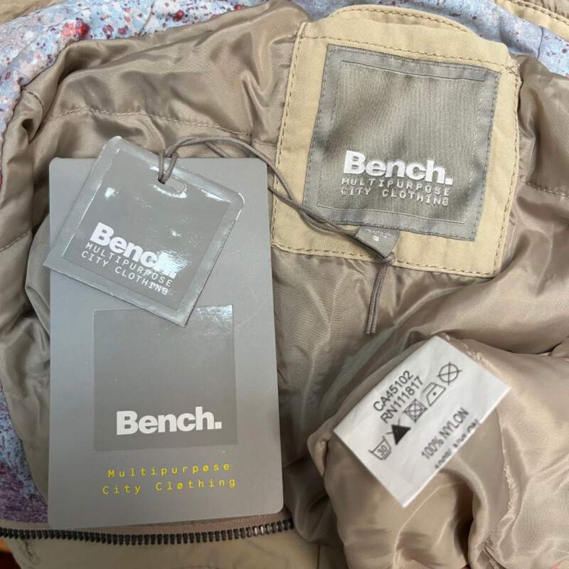 New Bench Warm Luxury Jacket<br />
Drawstring Waist<br />
Hood with Cute Watercolor Detail<br />
Zip and Button Closure<br />
Color: Khaki<br />
Size: Small