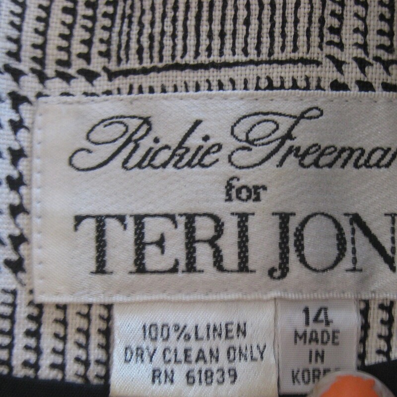 This gorgeous high end strategically designed dress is definitely of its time because of the wild buttons. You either love them or hate them.  But the dress itself is high quality small houndstooth check linen with short sleeves.  It's black and white.   The sleeves and sides are black which a very slimming design feature.<br />
the dress is fully lined and has big shoulder pads and side pockets.<br />
It buttons all the way open.<br />
It's Rickie Freeman for Teri Jon.<br />
The dress is labeled size 14 and was made in Hong Kong<br />
Here are the flat measurements, please double where appropriate:<br />
Shoulder to shoulder: 17<br />
Armpit to armpit: 22.5<br />
Waist: 18.75<br />
Hip: 22.25<br />
Length: 40.75<br />
Excellent condition, no flaws!<br />
Thank you for looking.<br />
#72243