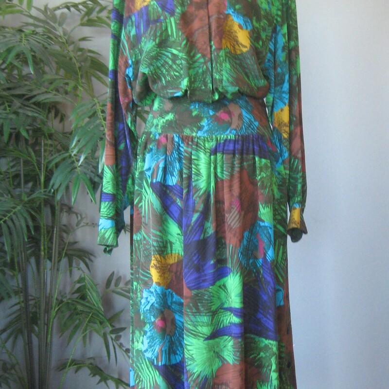 Two piece set is done in green, blue and brown tropical print silk<br />
to mix match or use just for the large amount of gorgeous silk<br />
You get :<br />
Long sleeve button down shirt with one chest pocket marked size 8, but will fit a modern size large<br />
A high waisted button down very full gathered skirt with a wide yoke.  It buttons all the way open down the side.<br />
Both pieces are unline<br />
Measurements provided are taken flat across the garments<br />
Skirt: marked size 14<br />
waist: 17.5<br />
hips: free<br />
length: 35<br />
Shirt:<br />
Medium Shoulder pads, semi sheer, marked size 8<br />
armpit to armpit: 22.5<br />
length: 28<br />
underarm sleeve seam: 21<br />
Thanks for looking!<br />
#72258