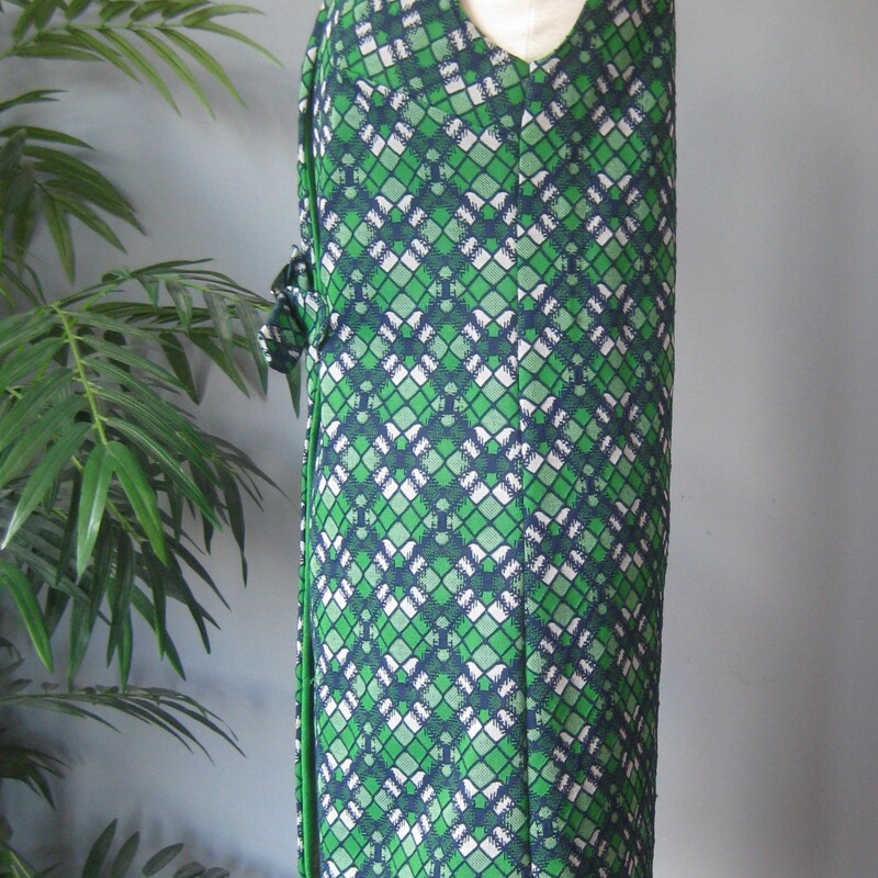 Simple midi length vest from Sears, probably made in the 1970s<br />
Green and blue geometric print with a gold sliding buckle closure<br />
sturdy washable polyester<br />
<br />
These are fun to style and the color on this one is so pretty<br />
<br />
Vest are great for working in a cold studio or office, especially this one which is lined - it will keep your core warm without bulking up your arms.<br />
<br />
Perfect condition.<br />
should fit a size small-medium<br />
flat measurements:<br />
armpit to armpit: 18<br />
length: 36 1/2<br />
<br />
thanks for looking!<br />
#73070