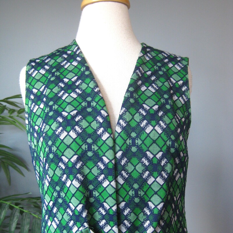 Simple midi length vest from Sears, probably made in the 1970s<br />
Green and blue geometric print with a gold sliding buckle closure<br />
sturdy washable polyester<br />
<br />
These are fun to style and the color on this one is so pretty<br />
<br />
Vest are great for working in a cold studio or office, especially this one which is lined - it will keep your core warm without bulking up your arms.<br />
<br />
Perfect condition.<br />
should fit a size small-medium<br />
flat measurements:<br />
armpit to armpit: 18<br />
length: 36 1/2<br />
<br />
thanks for looking!<br />
#73070