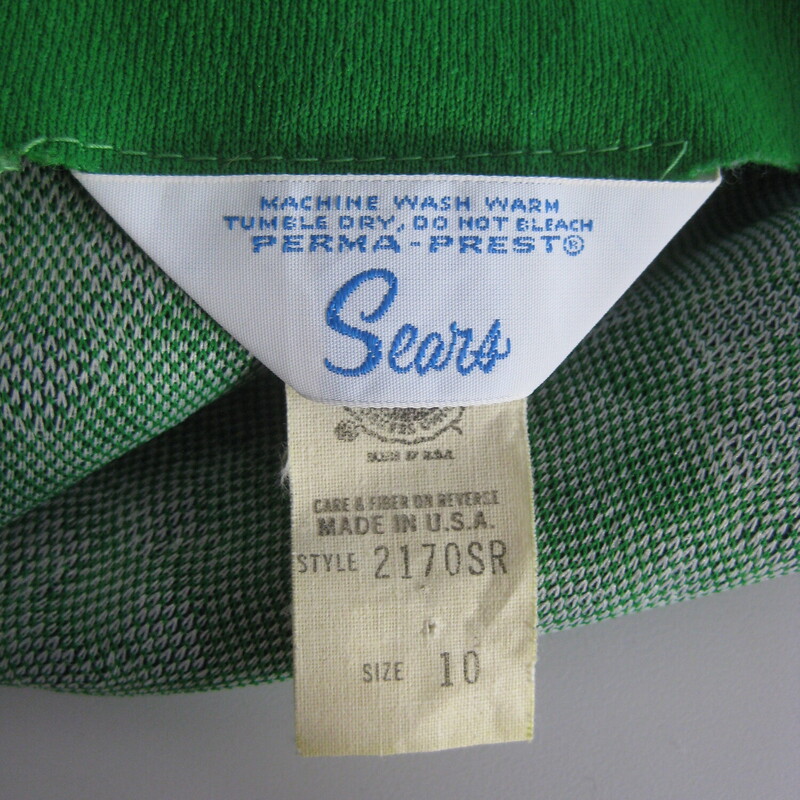 Simple midi length vest from Sears, probably made in the 1970s<br />
Green and blue geometric print with a gold sliding buckle closure<br />
sturdy washable polyester<br />
<br />
These are fun to style and the color on this one is so pretty<br />
<br />
Vest are great for working in a cold studio or office, especially this one which is lined - it will keep your core warm without bulking up your arms.<br />
<br />
Perfect condition.<br />
should fit a size small-medium<br />
flat measurements:<br />
armpit to armpit: 18<br />
length: 36 1/2<br />
<br />
thanks for looking!<br />
#73070