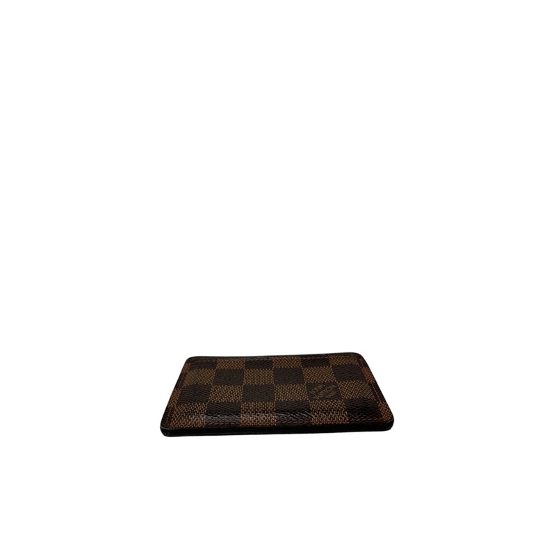 Louis Vuitton Damier Ebene Card Holder<br />
<br />
Date Code: Microchip.<br />
<br />
Dimensions:<br />
4.3 x 2.8 x 0.2 inches<br />
(Length x Height x Width)<br />
<br />
Does not come with original box or dust bag.<br />
<br />
Good Condition: Some warping of the leather and wear around the edges and corners.