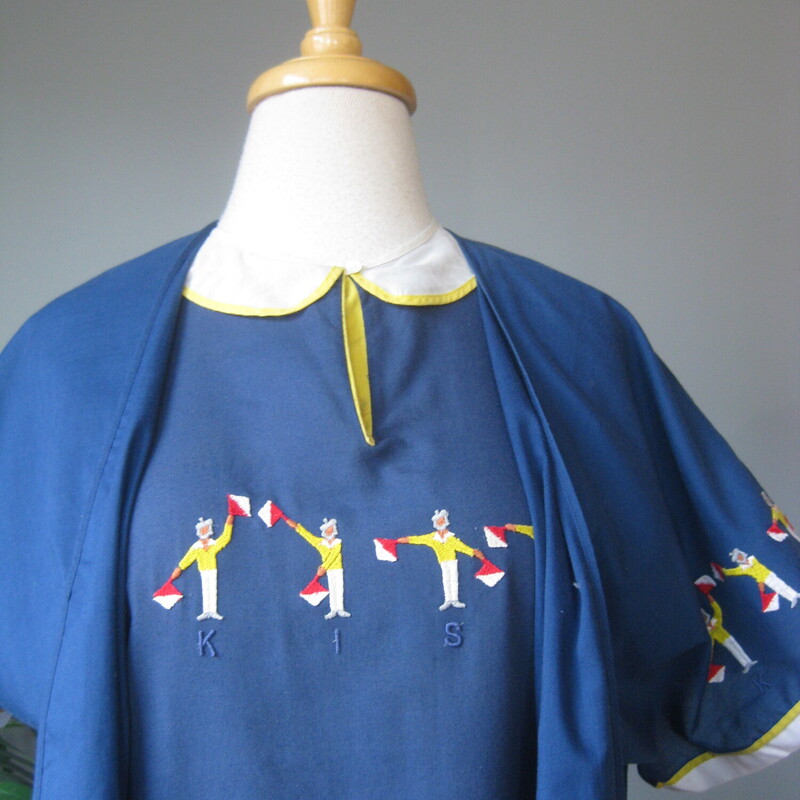 Super interesting night gown and robe set.<br />
Very lightweight blue cotton blend embroidered set made in Italy by<br />
Malizia.<br />
The robe has short sleeves each one embroidered with semaphore bearing sailors spelling out the word kiss.<br />
The nightgown has the sailors embroidered on the front and it has a keyhole like neckline outlined in yellow.<br />
Pretty and presentable, packs easily for travel when necessary.<br />
Excellent vintage condition.<br />
No size tag.<br />
the night gown measures 19.5 flat at the armpit, 20 across at the waist, 21.5 at the hip and it's 43.25 in length<br />
<br />
thanks for looking!<br />
#77674