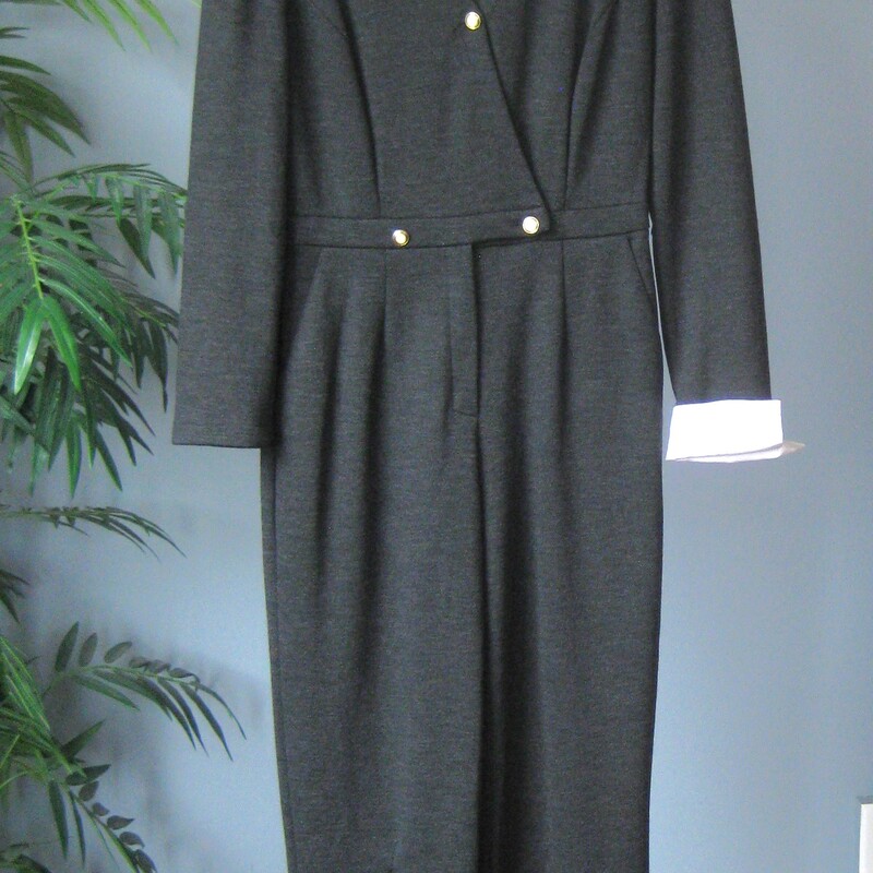 Vtg Escada Knit, Gray, Size: Large<br />
Vintage jumpsuit by Margaretha Ley for Escada made in Germany in the 1990s, after the fall of the Berlin  Wall.<br />
Gray wool knit, with a bit of but not too much stretch.<br />
White cotton collar and french cuffs that can be removed easily with hidden buttons.<br />
fancy modled buttons.<br />
Pockets at each hip<br />
Marked size 40, From the measurements and the character of the fabric, I would call this a size small or perhaps medium.<br />
Please use these measurements to be sure it will fit your body:<br />
Flat measurements:<br />
shoulder to shoulder: 17<br />
armpit to armpit: 18<br />
waist: 15<br />
hip: 19.5<br />
rise: 27.5<br />
inseam: 28.5<br />
excellent vintage condition.<br />
thanks for looking!<br />
#80691