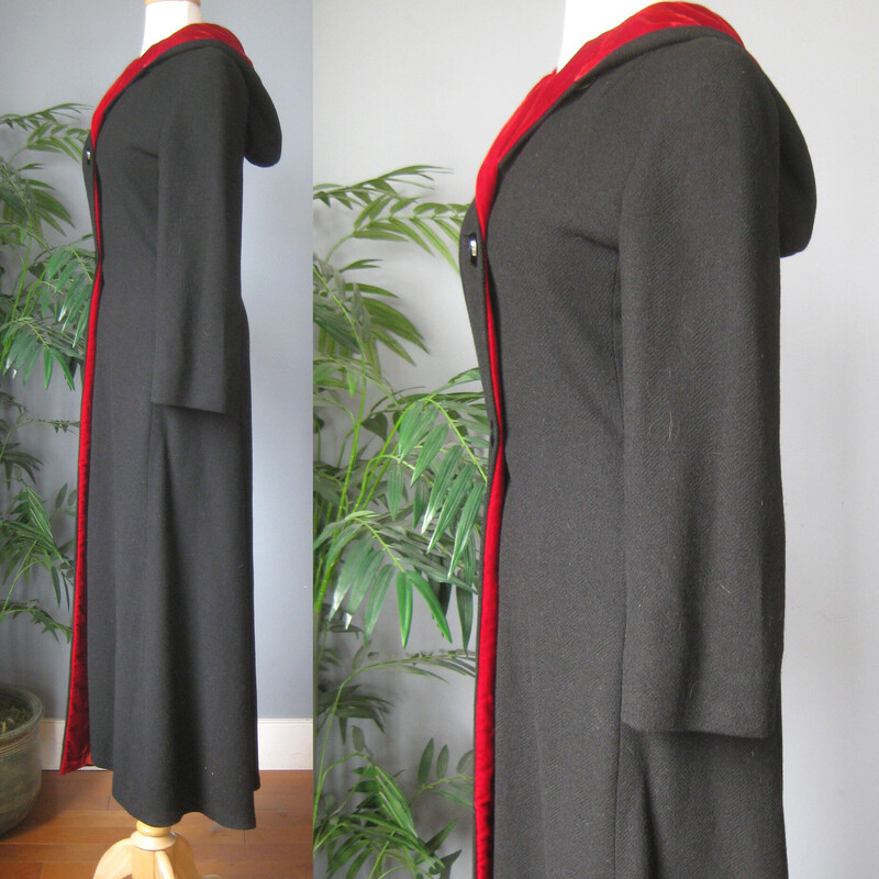 Long and Slim Black Wool coat with a hood.
Romantic and striking!
Seems to have been handmade.
The hood and front facing is lined with red velvet.
The body of the coat has a warm interlining and another orange lining next to the body.
Button Closure
It's quite small.  Made for a teenager's body.  My mannequin fits a modern size 4 nicely.  This coat does button up on my mannequin but it is too snug for practical purposes.
Here are the flat measurements, please double where appropriate:
Shoulder to shoulder: 17
Armpit to armpit: 18
Waist: 14.75
Hip: 19.5
Underarm sleeve seam length: 16
Length: 55.5  This might be long for your teen but it wouldn't be too hard to take it up.
Excellent condition  The only flaw is some stains on one part of the orange lining as shown.
Thanks for looking!
#82459