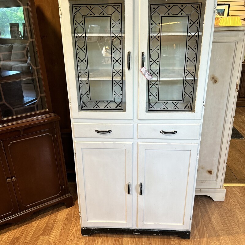 Ant. Art Deco Cupboard,
 Size: 65 X 31 X 12
White antique period cupboard with black detailing on glass. 3 moving towel bars on the side.
This is a great piece!