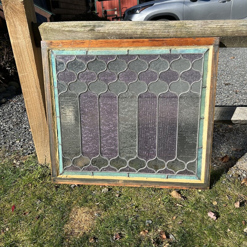 Stained Glass WIndow<br />
 Size: 32.5 X 30<br />
This is an original leaded stained glass window from a beautiful home.  All the glass is textured (translucent) allowing light to enter but it can not be seen through.  There is a beveled edge of a pale green with alternating panes of pale lavender and pale green.  The panes have differing texture patterns on them - some look like ice crystals that form on windows in the cold.  There is a wooden frame and two brass bars on the back side.  It is in very good condition.