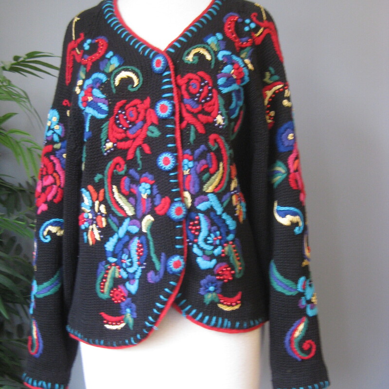 Chunky, colorful, warm  cardigan sweater by Gantos<br />
It's black with bold yarn embroidery dotted with metallic round beads<br />
The yarn covered buttons on the outside are decorative, inside the front edge are easy to work with small black plastic buttons.<br />
The front, sleeves and shoulders are decorated.<br />
Marked size small but should fit a modern medium as well<br />
flat measurements:<br />
armpit to armpit: 21<br />
width at hem: 21<br />
length: 21<br />
<br />
Excellent condition no flaws<br />
thanks for looking!<br />
#77507