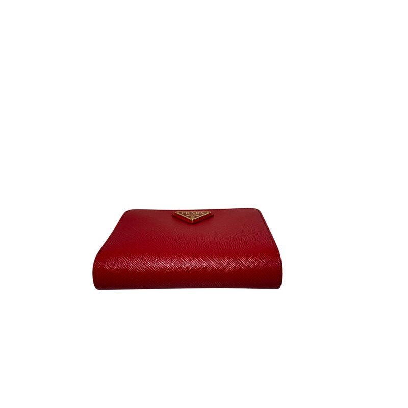 Prada Portafoglio Lamp Red Wallet<br />
<br />
Factory Code: 107F<br />
<br />
Dimensions:<br />
Height : 3.54 in.<br />
Depth : 1.18 in.<br />
Width : 14cm<br />
<br />
In very good condition. Light wear theoughout the wallet.<br />
<br />
Comes with original dust bag and box.