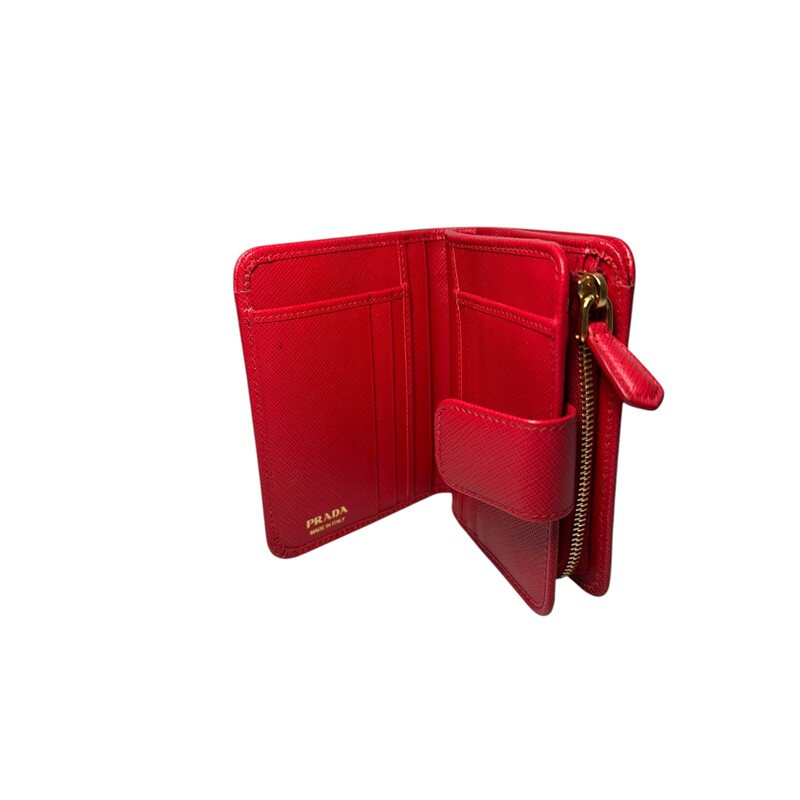 Prada Portafoglio Lamp Red Wallet<br />
<br />
Factory Code: 107F<br />
<br />
Dimensions:<br />
Height : 3.54 in.<br />
Depth : 1.18 in.<br />
Width : 14cm<br />
<br />
In very good condition. Light wear theoughout the wallet.<br />
<br />
Comes with original dust bag and box.