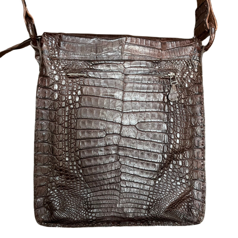 Rhonda Ochs Crocodile Crossbody Bag<br />
Snap Adjustable Shoulder Strap<br />
Dual Exterior Pockets<br />
Suede Lining & Single Interior Pocket<br />
Flap & Snap Closures at Top<br />
Dust Bag<br />
Color: Brown<br />
Estimated item measurements<br />
Shoulder Strap Drop: 20.75<br />
Height: 14.5<br />
Width: 12.5<br />
Depth: 0.75