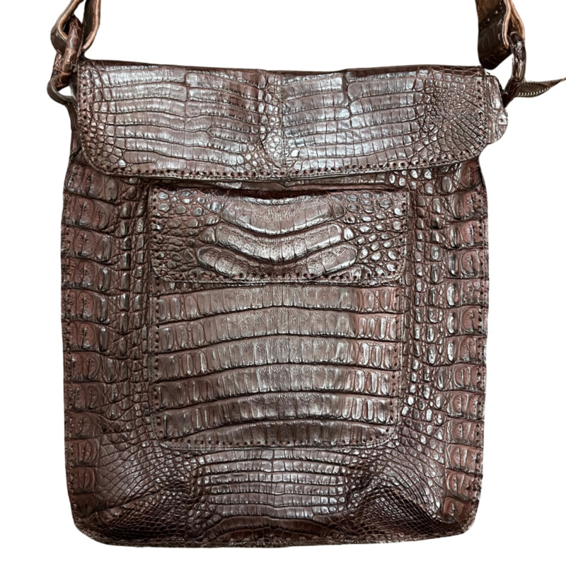 Rhonda Ochs Crocodile Crossbody Bag<br />
Snap Adjustable Shoulder Strap<br />
Dual Exterior Pockets<br />
Suede Lining & Single Interior Pocket<br />
Flap & Snap Closures at Top<br />
Dust Bag<br />
Color: Brown<br />
Estimated item measurements<br />
Shoulder Strap Drop: 20.75<br />
Height: 14.5<br />
Width: 12.5<br />
Depth: 0.75