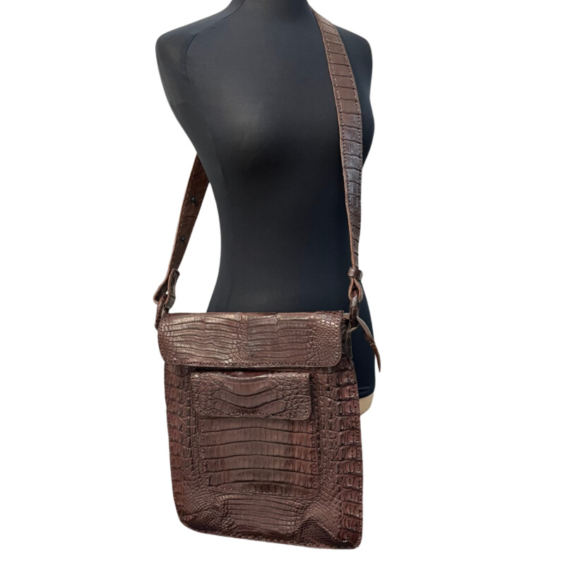 Rhonda Ochs Crocodile Crossbody Bag<br />
Snap Adjustable Shoulder Strap<br />
Dual Exterior Pockets<br />
Suede Lining & Single Interior Pocket<br />
Flap & Snap Closures at Top<br />
Dust Bag<br />
Color: Brown<br />
Estimated item measurements<br />
Shoulder Strap Drop: 20.75<br />
Height: 14.5<br />
Width: 12.5<br />
Depth: 0.75