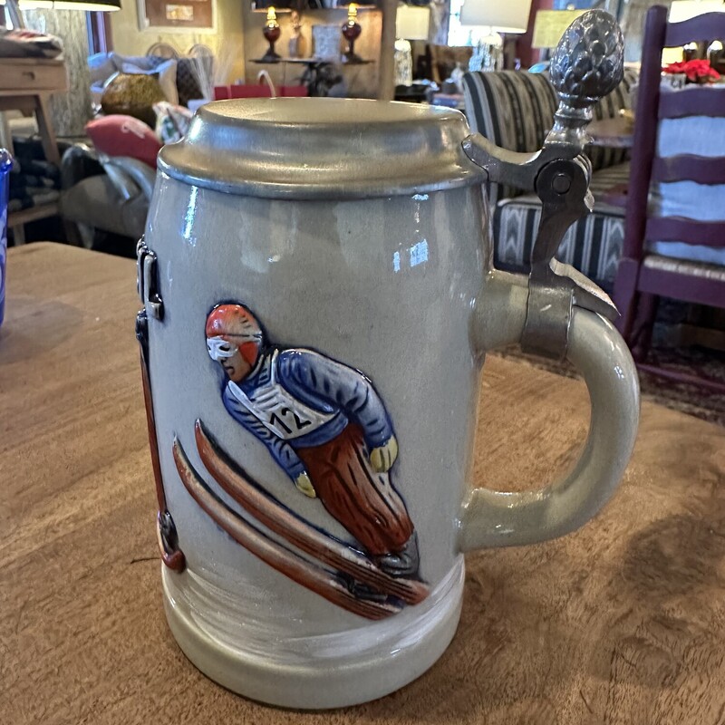 Vinatge German Beer Stein<br />
<br />
Size: 7T<br />
<br />
Ski Heil stoneware stein from Western Germany with bas relief skiers and pewter lid with pineapple finial on handle.  The bottom is stamped Original KING 3 and the number 420.