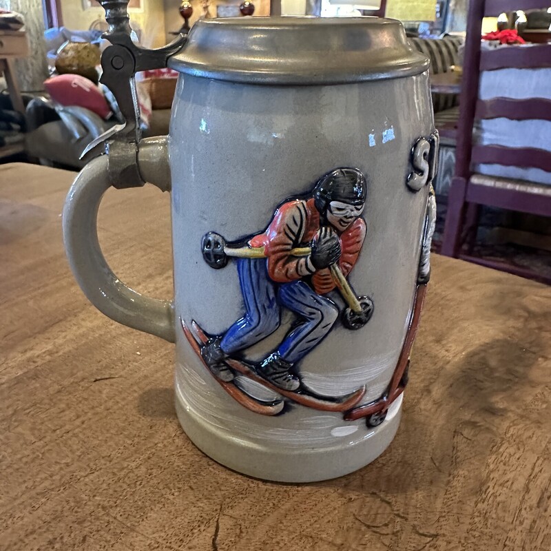 Vinatge German Beer Stein

Size: 7T

Ski Heil stoneware stein from Western Germany with bas relief skiers and pewter lid with pineapple finial on handle.  The bottom is stamped Original KING 3 and the number 420.