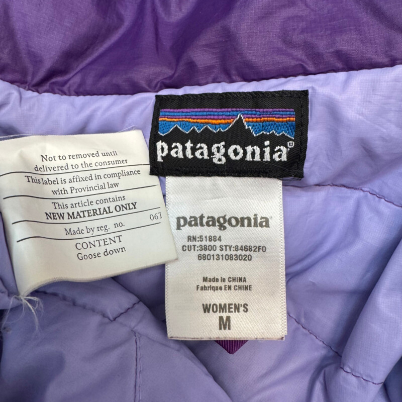 Patagonia Down Jacket<br />
Flawed Gem   See Photos<br />
Zipper Closure<br />
Color:  Purple<br />
Size: Medium<br />
Still a Cute and Warm Jacket!