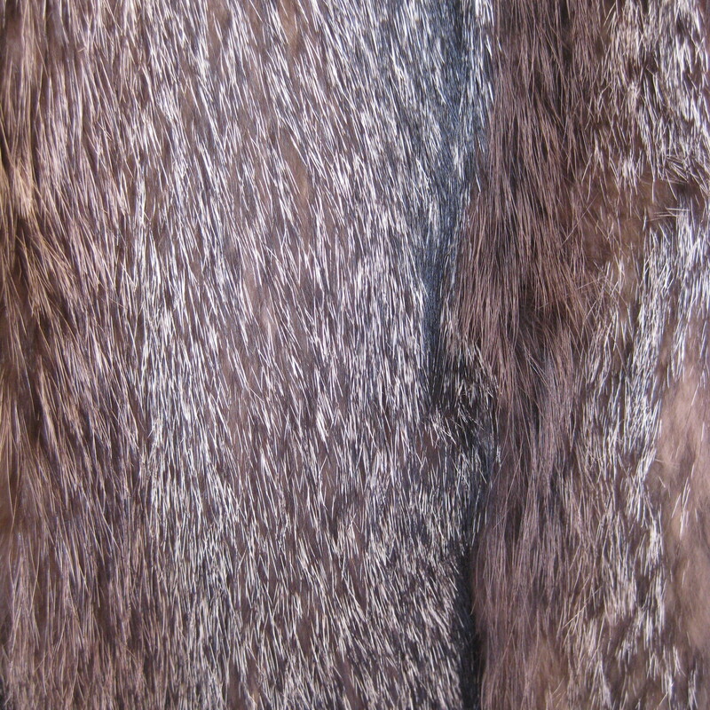 Make a statement in this striking vintage fur jacket.<br />
The fur which I think is mainly raccoon is beautifully matched and composed with vertical strips of a the stiffer variegated fur alternating with strips of a super soft and less structured fur.<br />
<br />
Fully lined<br />
Wide 3/4 sleeves<br />
It has one hook and eye at about the center of the front and fancy button at the neck, unfortunately the loop for that button is broken. But other the jacket is in excellent condition!<br />
Flat measurements, taken on the inside of the jacket.<br />
Armpit to armpit : 20<br />
Length: 24.5<br />
Thanks for looking.<br />
#82680