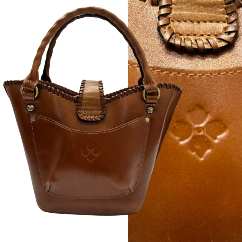 Patricia Nash Ninetta Handbag<br />
Tooled Leather<br />
Floral Detail<br />
Leather Whipstitching Trim<br />
Antiqued Gold Tone Hardware<br />
With Crossbody Strap<br />
Color: Camel