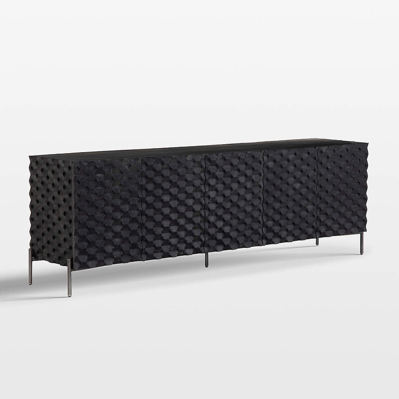 Raffael Media Console,<br />
<br />
Size: 82Lx18Wx27T<br />
<br />
A carved honeycomb pattern wraps Raffael's black-stained exterior in conversation-sparking texture and dimension. Crafted of renewable solid mango wood, from trees no longer producing fruit, each facet of the intricate door fronts highlights the wood's lively grain. Set on a minimalist base of gunmetal-finished iron, the console makes a sculptural addition to a living or family room. Raffael's seamless façade features five doors that open to three fixed shelves that house media components or provide storage.<br />
<br />
Raffael Black Carved Wood Storage Media Console.27.5Hheight82Wwidth18.25DdepthMeasurements are in inches.<br />
Mango wood doors with black stain<br />
Engineered wood side and back panel<br />
Iron base with gunmetal finish<br />
3 fixed shelves<br />
Cord management cutouts<br />
Levelers<br />
TV stand accommodates a flat screen TV up to 82w<br />
Made in India