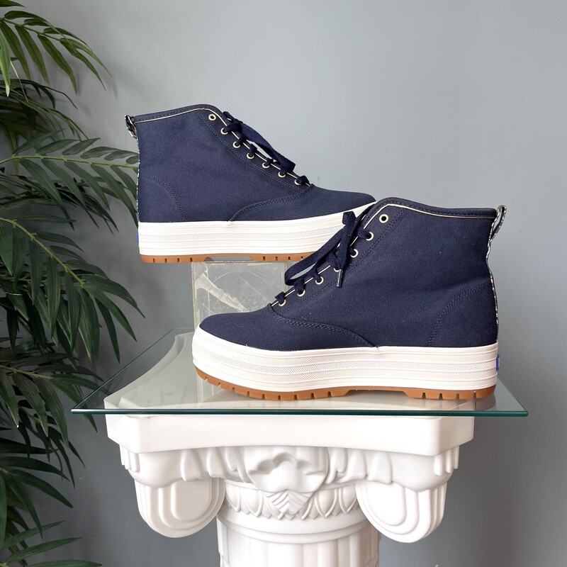 Irresistably pretty high top sneakers by keds, designed by the Rifle Paper Company.<br />
These are brand new.<br />
size 7<br />
They are sold out on the Keds Website.<br />
They have mid platforms and lug soles.<br />
Super wearable in Sold Navy Blue with floral accents<br />
If you would like me to ship them without the box for cheaper shipping, just let me know before you purchase and I'll adjust.<br />
<br />
thanks for looking!<br />
#82957