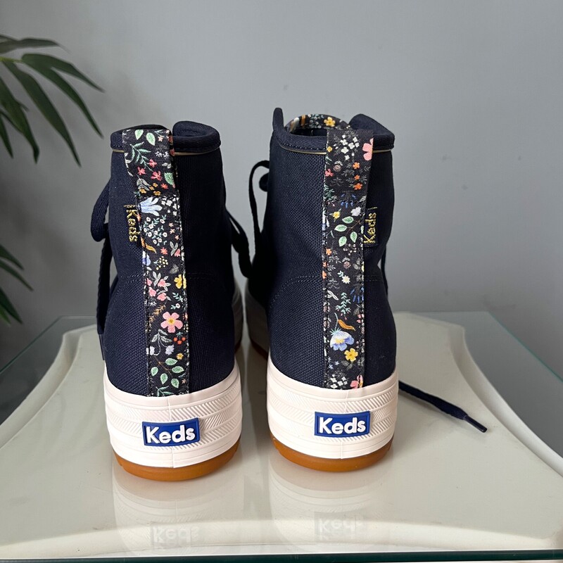 Irresistably pretty high top sneakers by keds, designed by the Rifle Paper Company.<br />
These are brand new.<br />
size 7<br />
They are sold out on the Keds Website.<br />
They have mid platforms and lug soles.<br />
Super wearable in Sold Navy Blue with floral accents<br />
If you would like me to ship them without the box for cheaper shipping, just let me know before you purchase and I'll adjust.<br />
<br />
thanks for looking!<br />
#82957